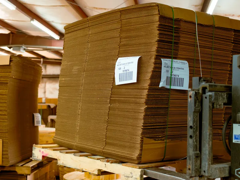 Banded bundles of corrugated sheets stacked in the warehouse