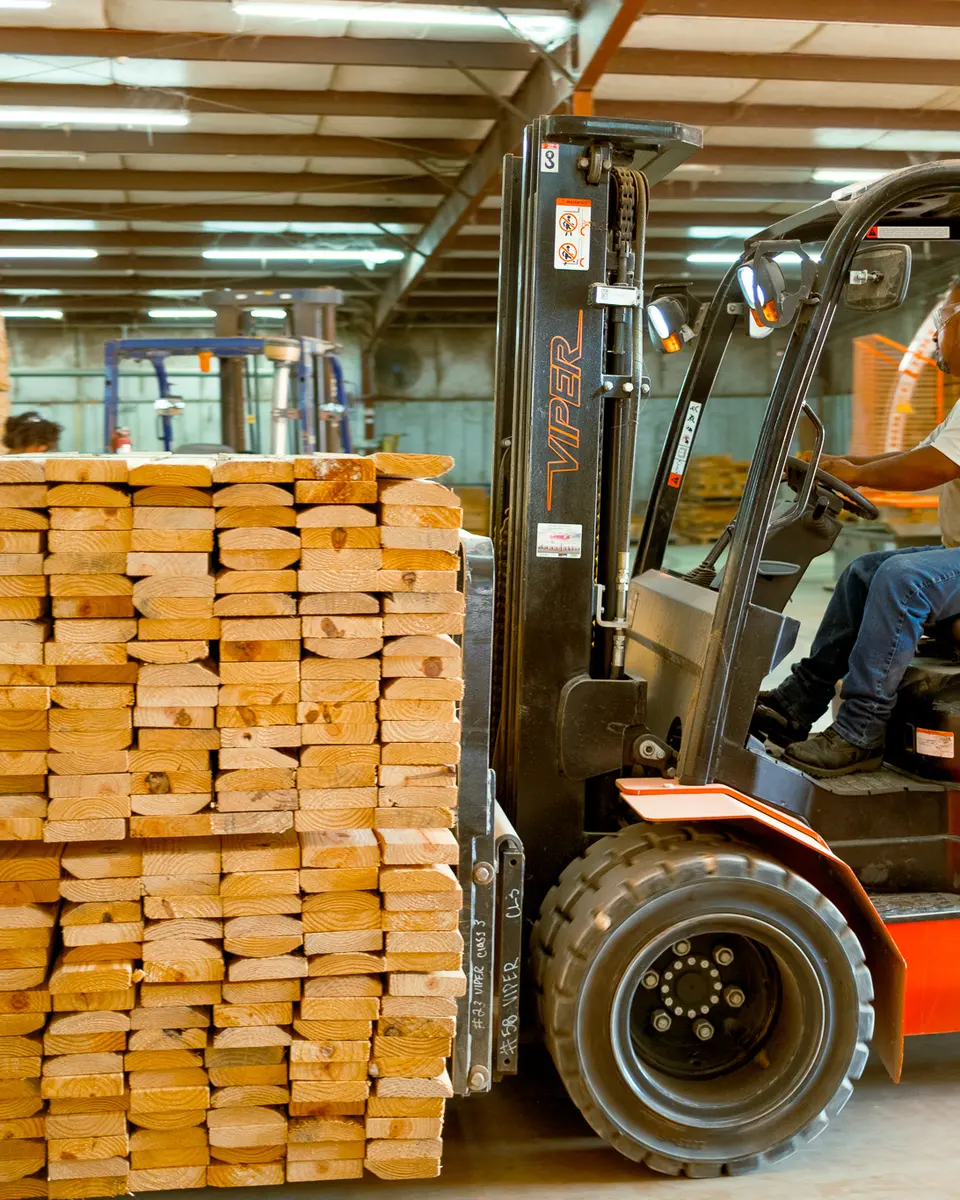 Forklift moving banded dunnage bundles